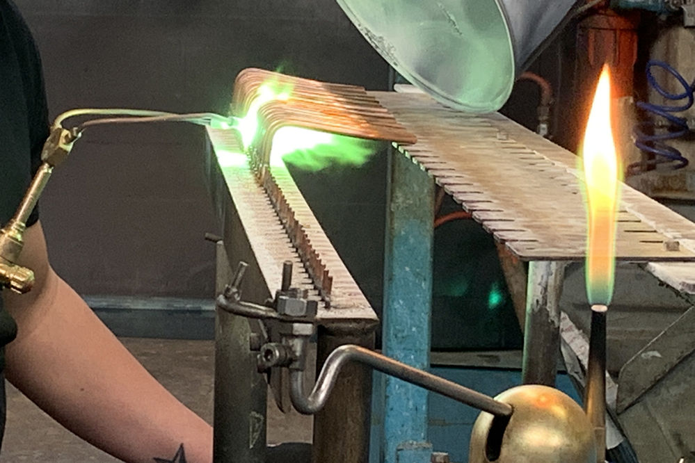 Master Artisan making copper pipes used in espresso machine parts in Italy by Bezzera, professional coffee machine